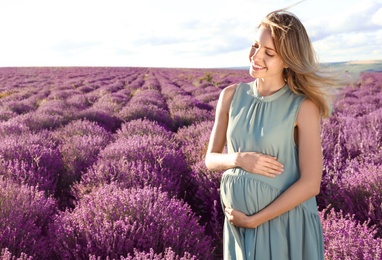 Photo of Pregnant woman in lavender field on summer day