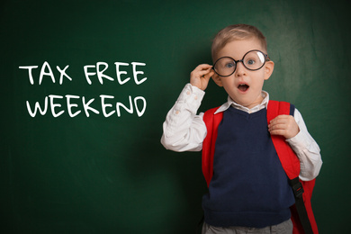 Image of Little boy with backpack and text TAX FREE WEEKEND written on chalkboard