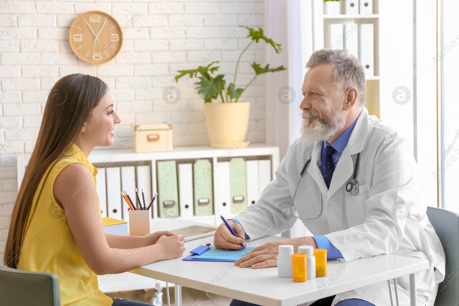 Photo of Mature doctor consulting patient in clinic