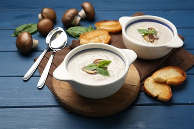 Fresh homemade mushroom soup served on blue wooden table