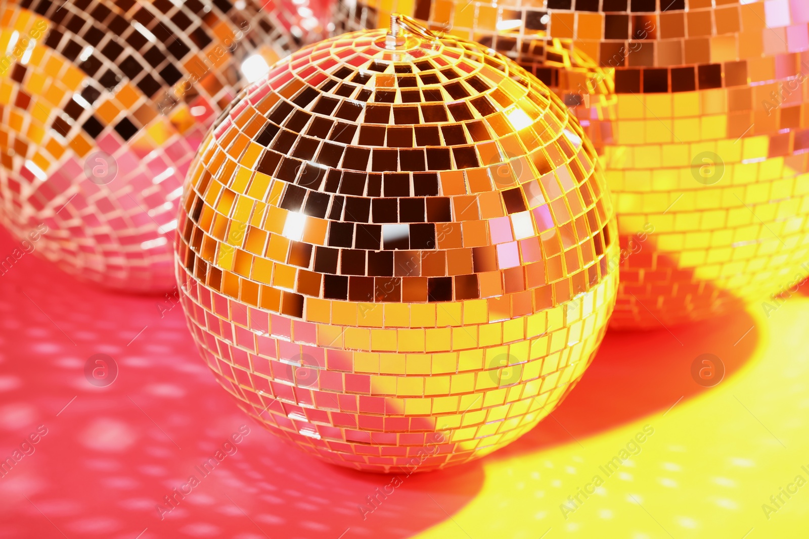 Photo of Many shiny disco balls on floor, color toned