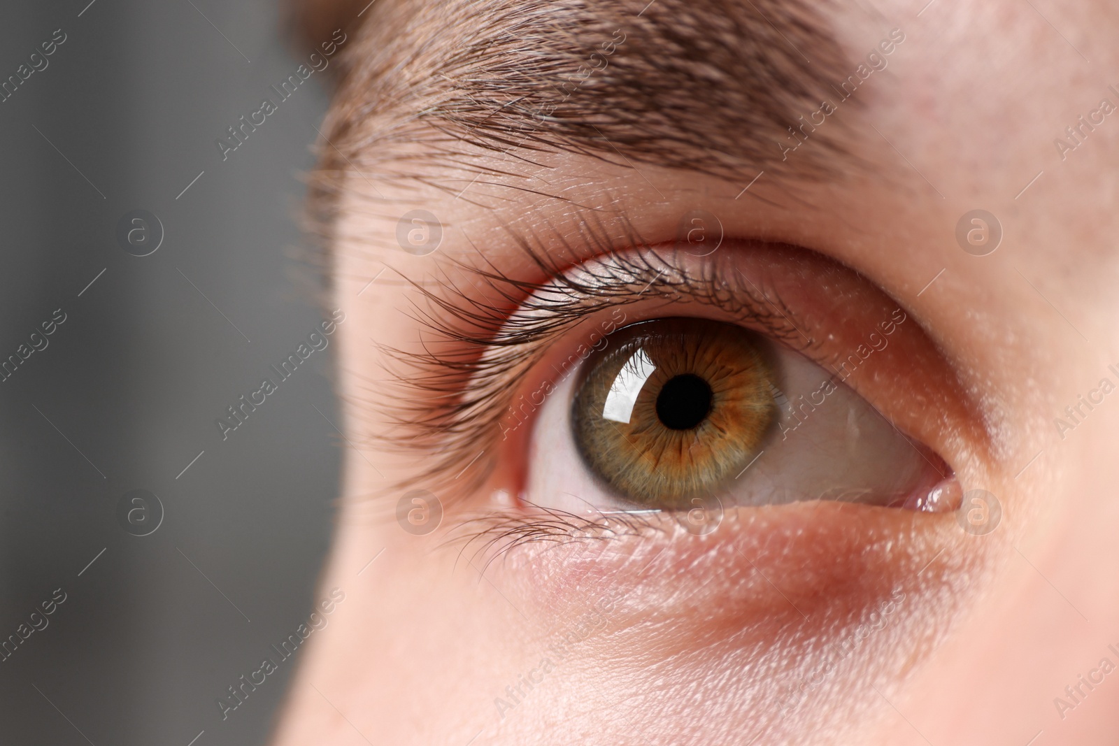 Photo of Man with beautiful eyes on blurred background, closeup