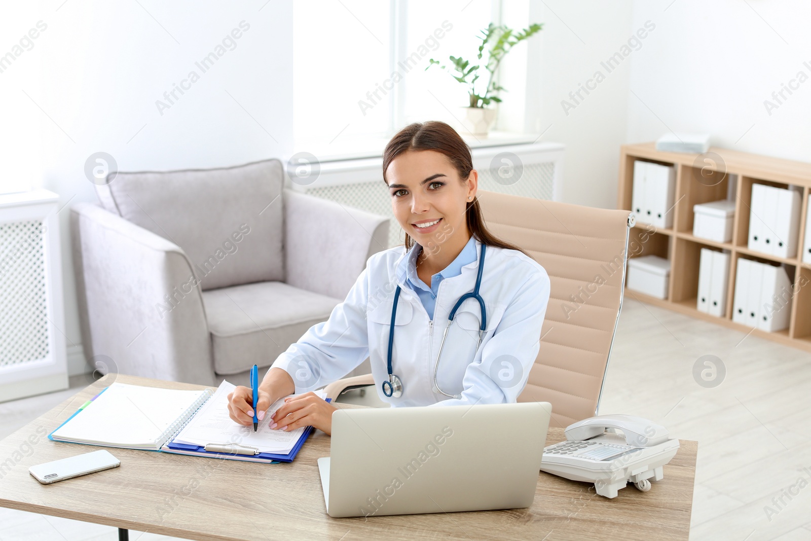 Photo of Female medical assistant at workplace in clinic. Health care service