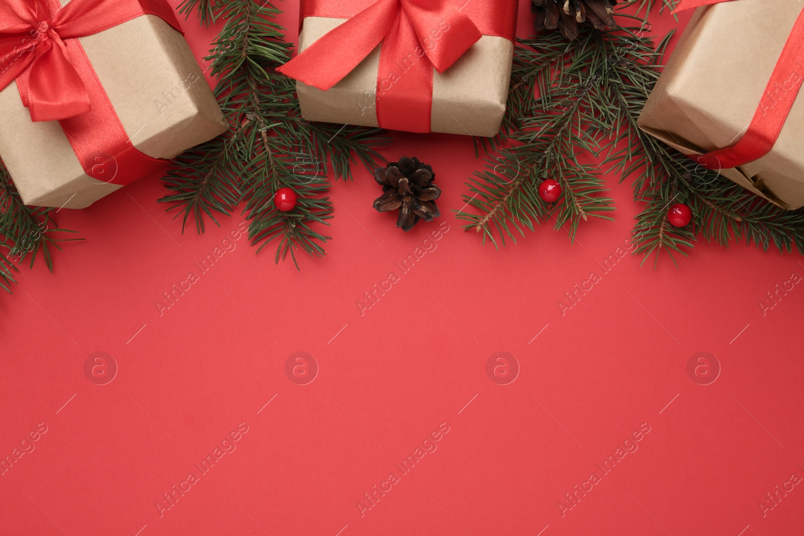 Photo of Flat lay composition with Christmas gifts on red background, space for text. Boxing day