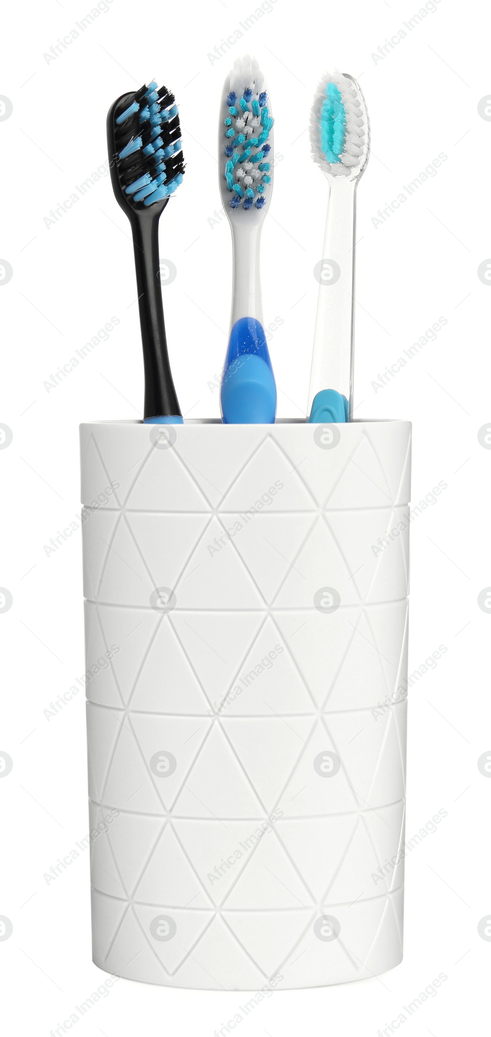 Photo of Different toothbrushes in holder isolated on white