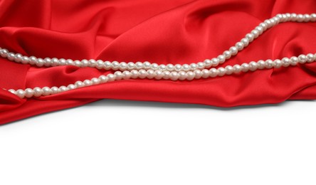 Photo of Beautiful pearls and red silk on white background
