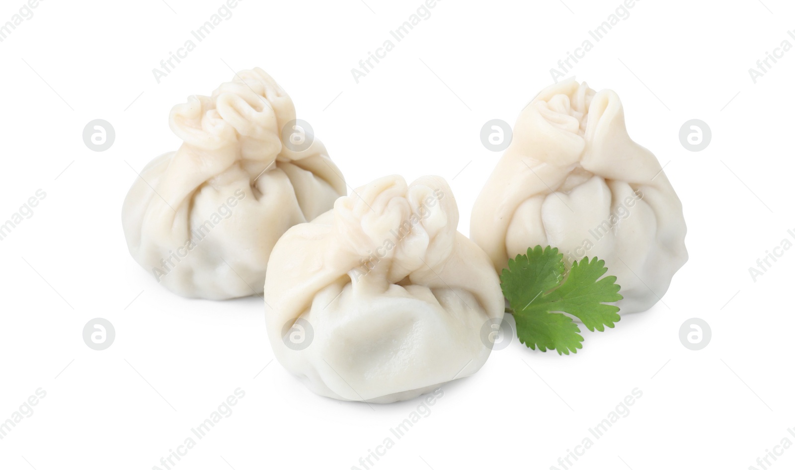 Photo of Three tasty khinkali (dumplings) and parsley isolated on white. Georgian cuisine