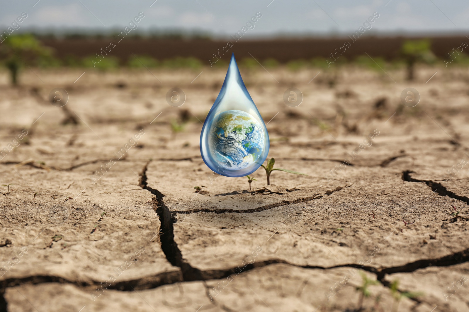 Image of Save environment. Drop with Earth falling on dry cracked land, closeup