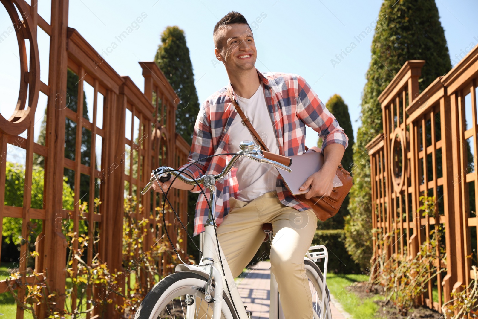 Photo of Man with laptop on bike in park