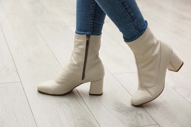 Photo of Woman wearing stylish leather shoes indoors, closeup