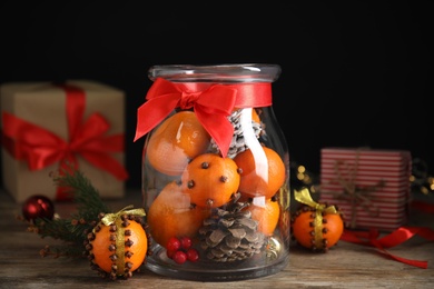 Christmas composition with tangerine pomander balls on wooden table