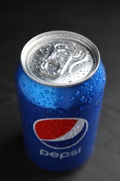 Photo of MYKOLAIV, UKRAINE - FEBRUARY 08, 2021: Can of Pepsi with water drops on black table, closeup