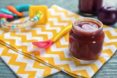 Jar with healthy baby food on table