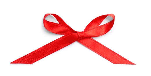 Photo of Red ribbon bow on white background, top view