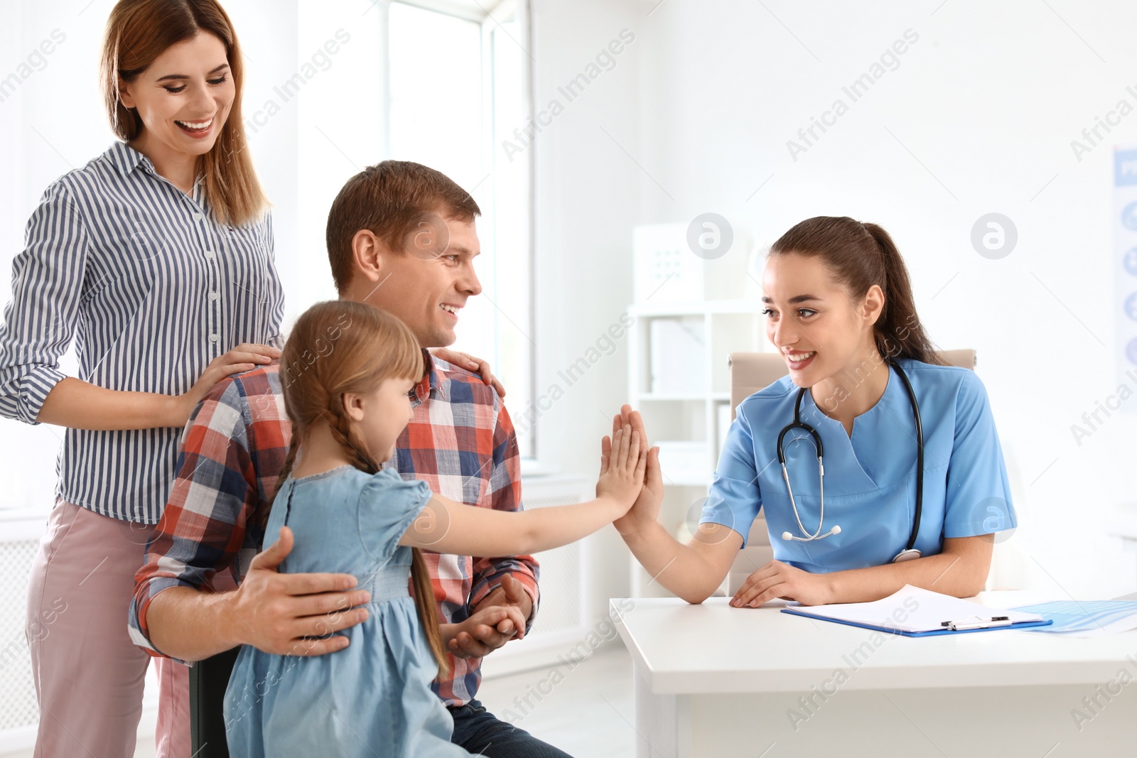 Photo of Parents with little daughter visiting children's doctor in hospital