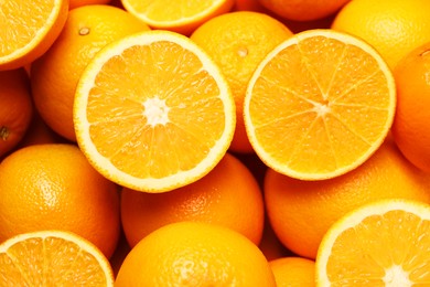 Photo of Tasty ripe fresh oranges as background, top view