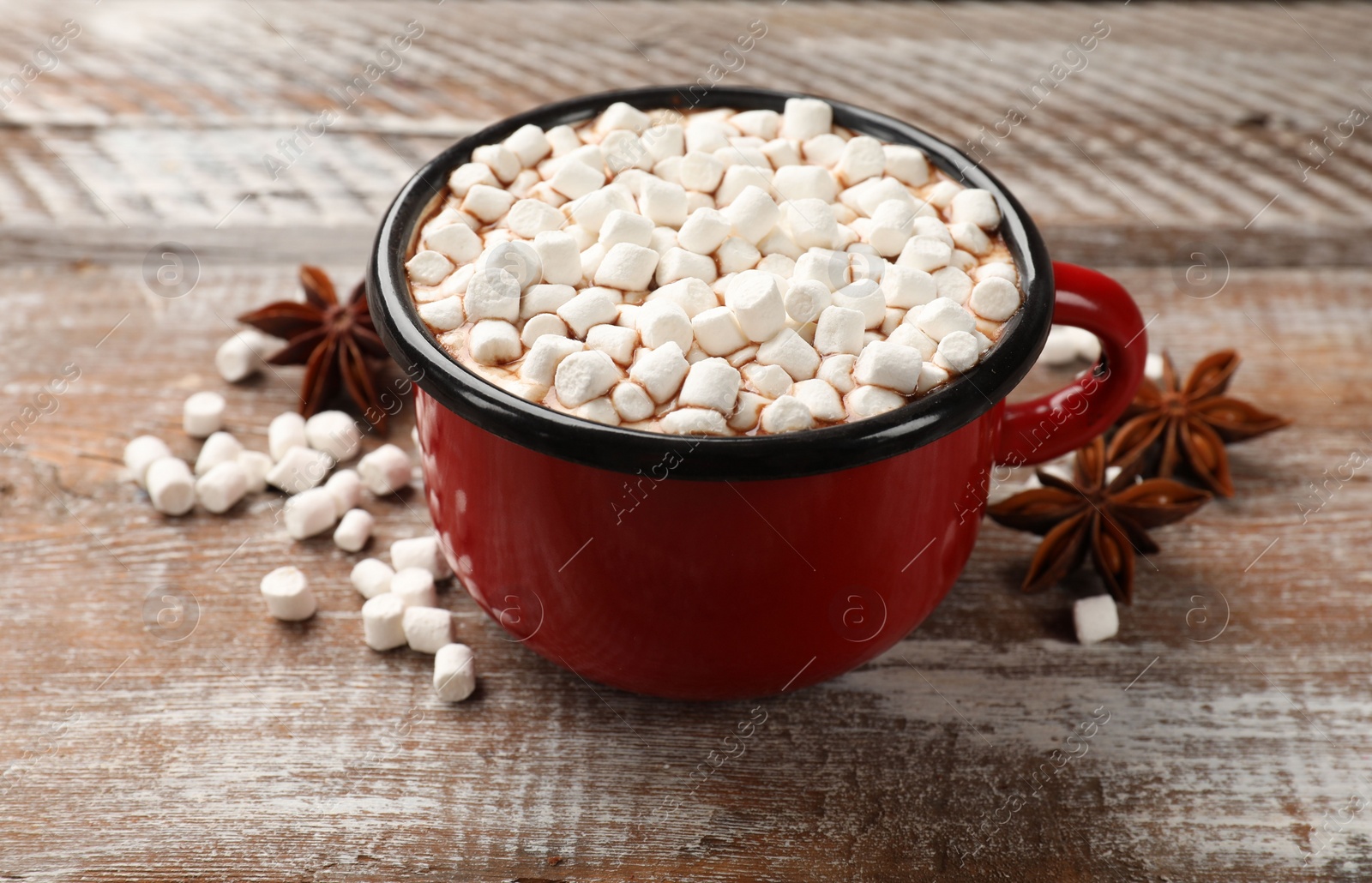 Photo of Tasty hot chocolate with marshmallows on wooden table, closeup