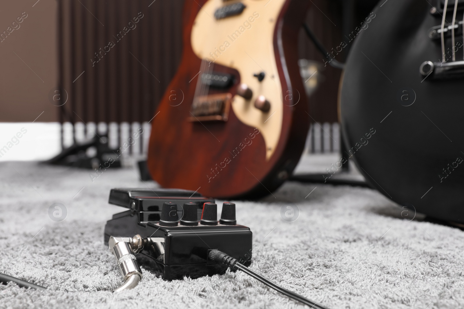 Photo of Electric guitar pedal at recording studio. Music band practice