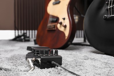 Photo of Electric guitar pedal at recording studio. Music band practice