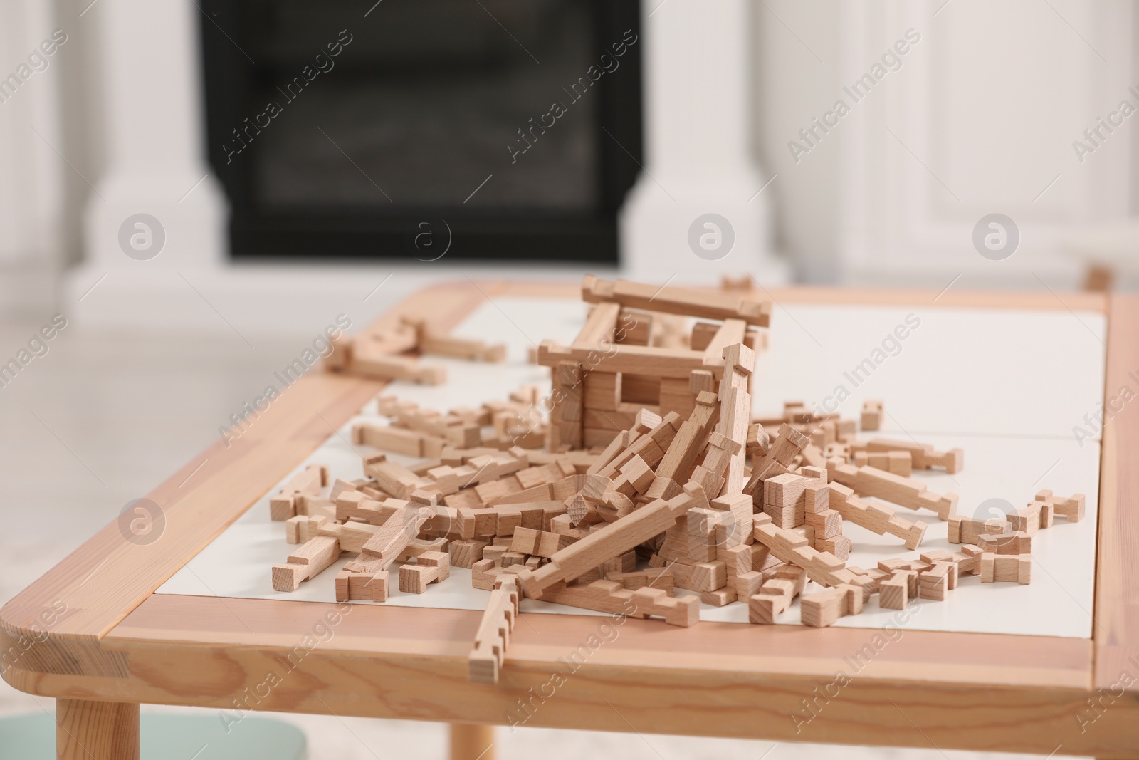 Photo of Wooden building blocks on table indoors. Educational toy for motor skills development