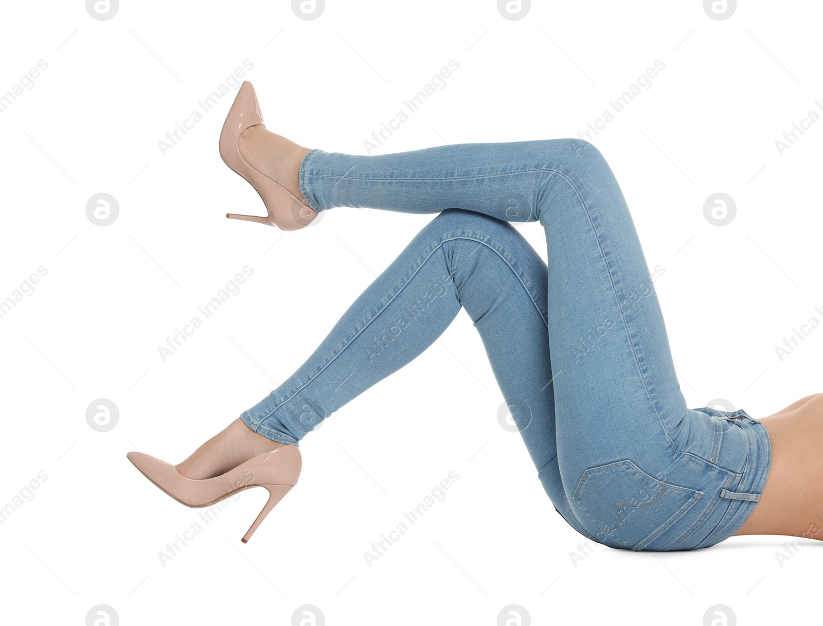 Photo of Woman wearing stylish light blue jeans and high heels shoes on white background, closeup
