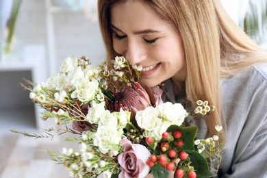 Female florist with beautiful bouquet at workplace