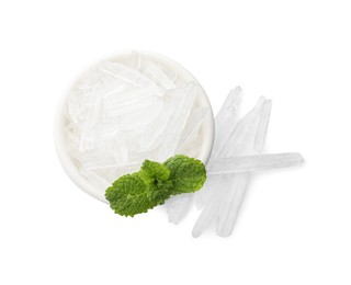 Menthol crystals and fresh mint leaves in bowl on white background, top view