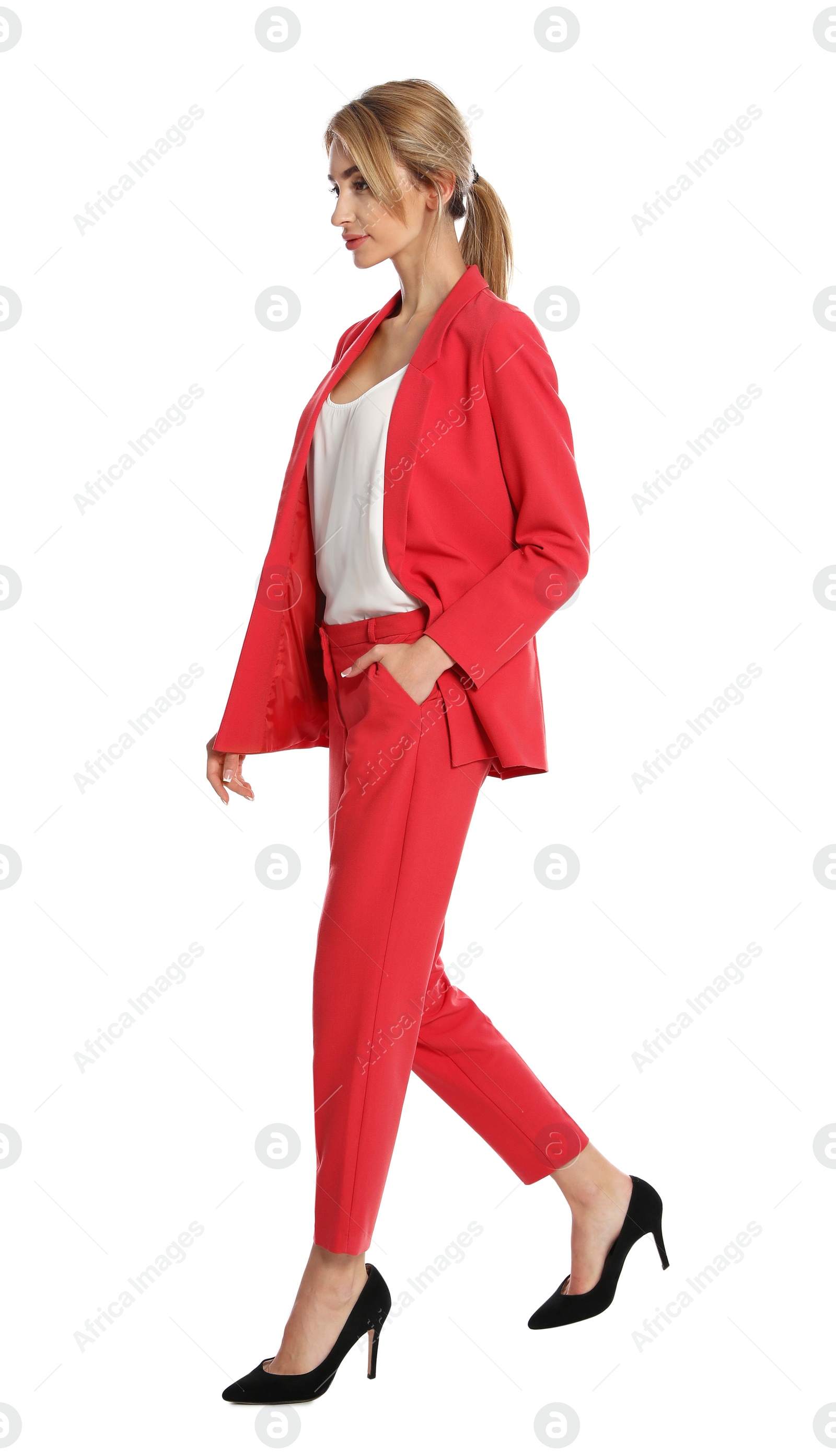 Photo of Beautiful young woman in red suit posing on white background