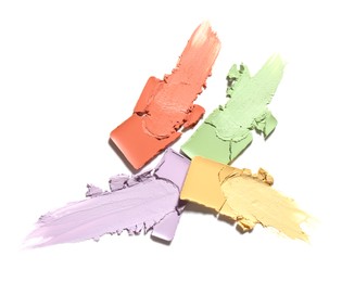 Samples of color correcting concealers isolated on white, top view