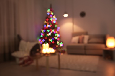 Photo of Blurred view of stylish room interior with decorated Christmas tree