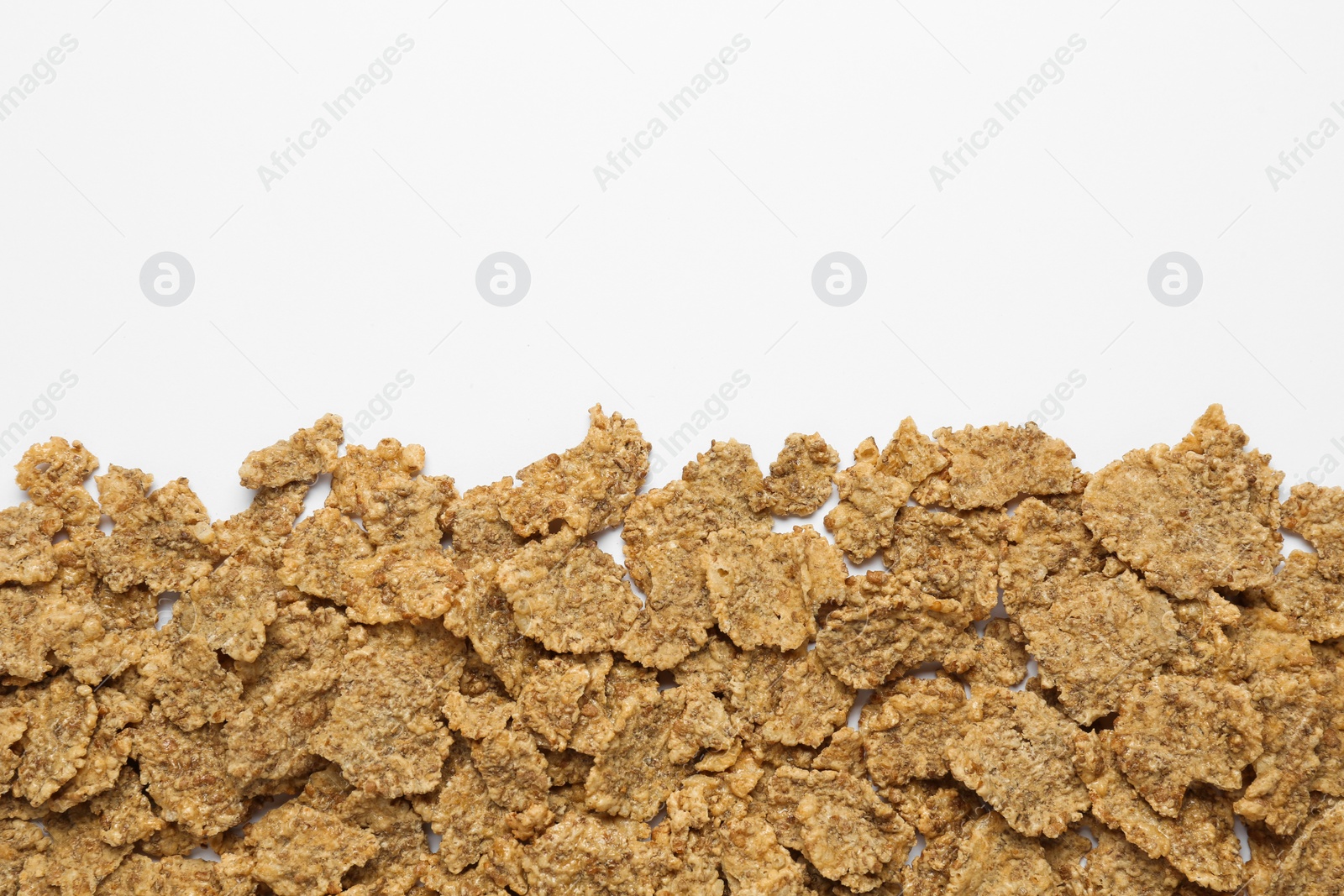 Photo of Sweet tasty corn flakes on white background, top view