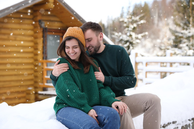 Photo of Lovely couple spending time together on snowy day. Winter vacation