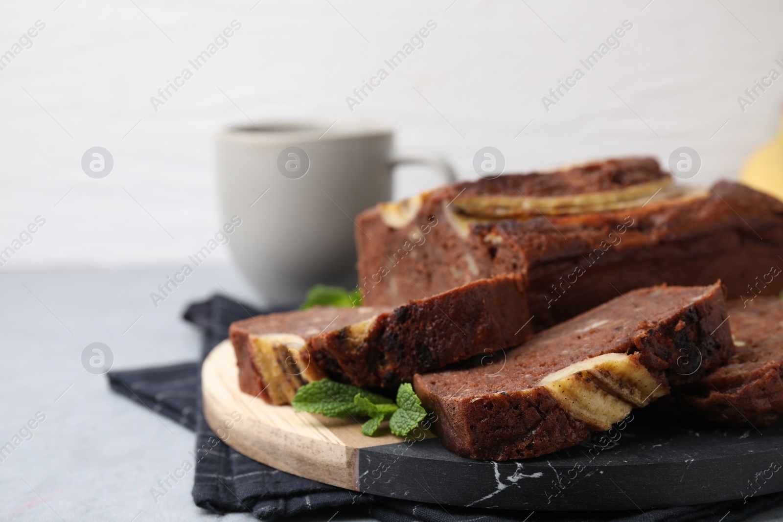 Photo of Delicious banana bread served on grey table, closeup