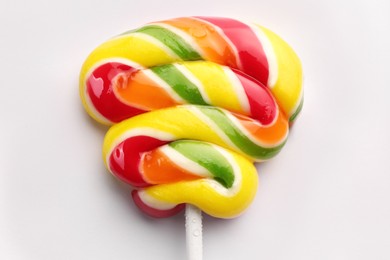 Photo of Sweet colorful lollipop on light background, top view