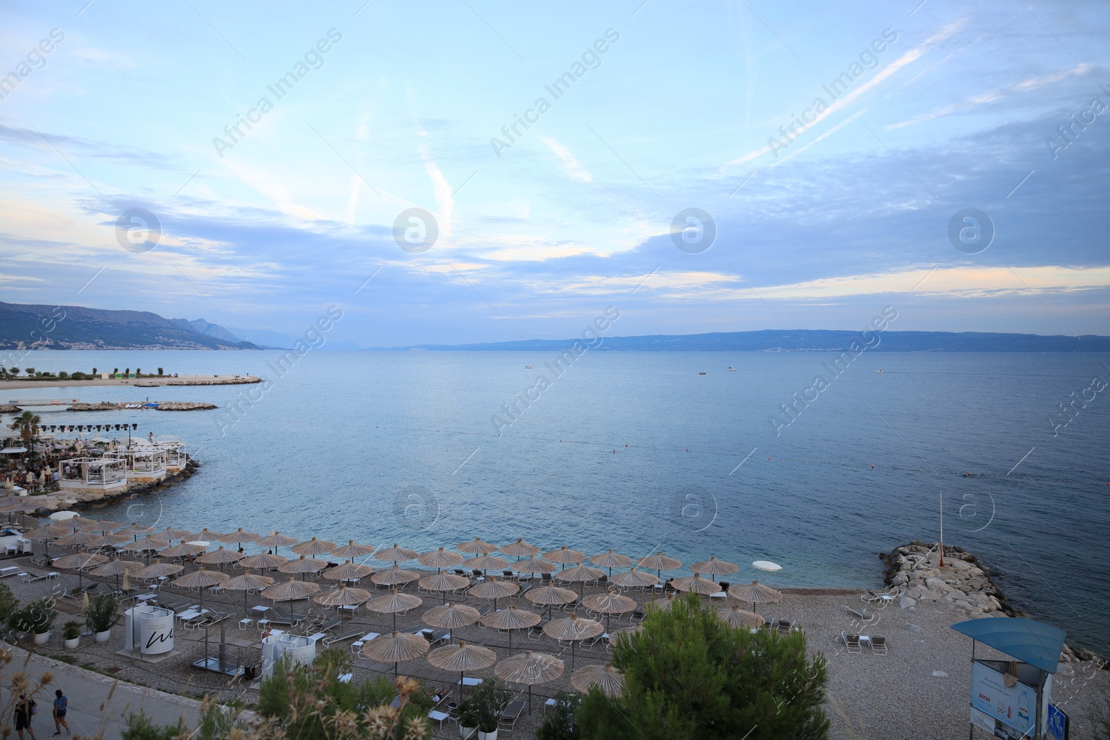 Photo of Many beach umbrellas near sea at resort