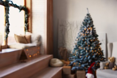 Photo of Blurred view of room with Christmas tree and festive decor