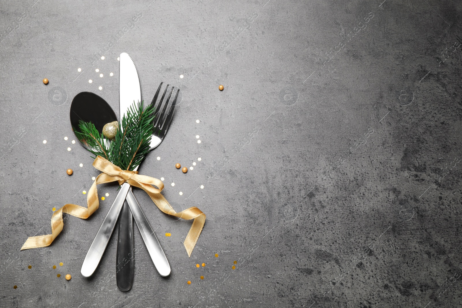 Photo of Cutlery set on grey table, flat lay. Space for text