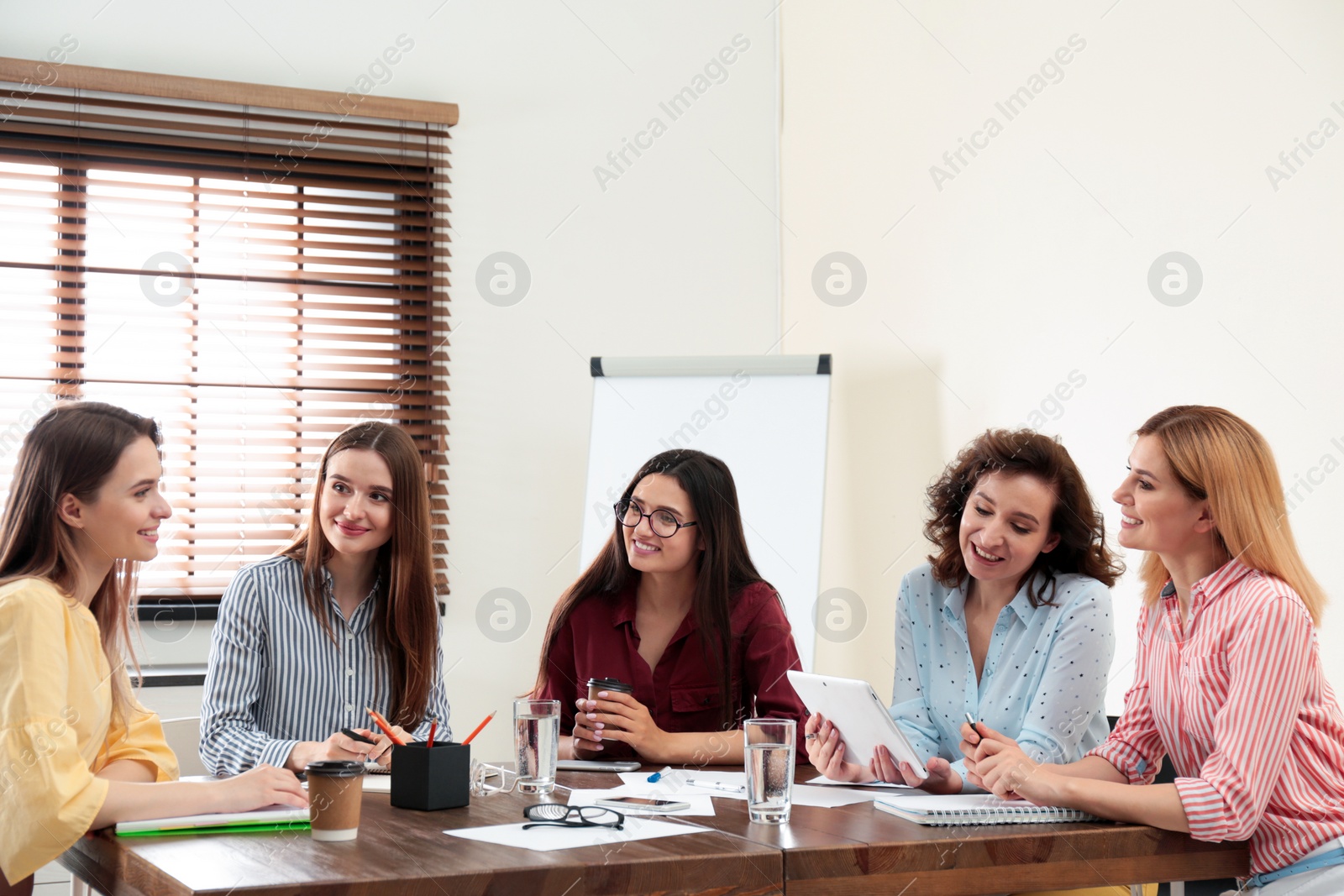 Photo of Female professional business team working in office. Women power concept