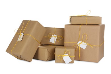 Photo of Parcels wrapped in kraft paper with tags on white background