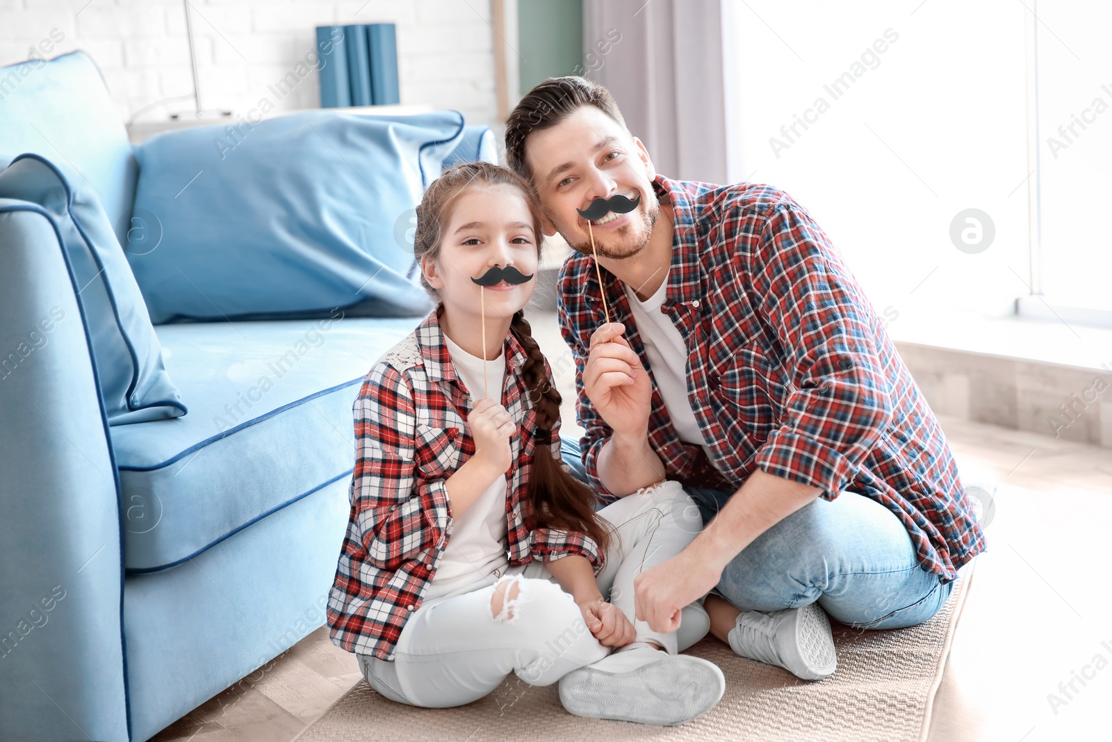 Photo of Dad and his daughter having fun at home. Father's day celebration