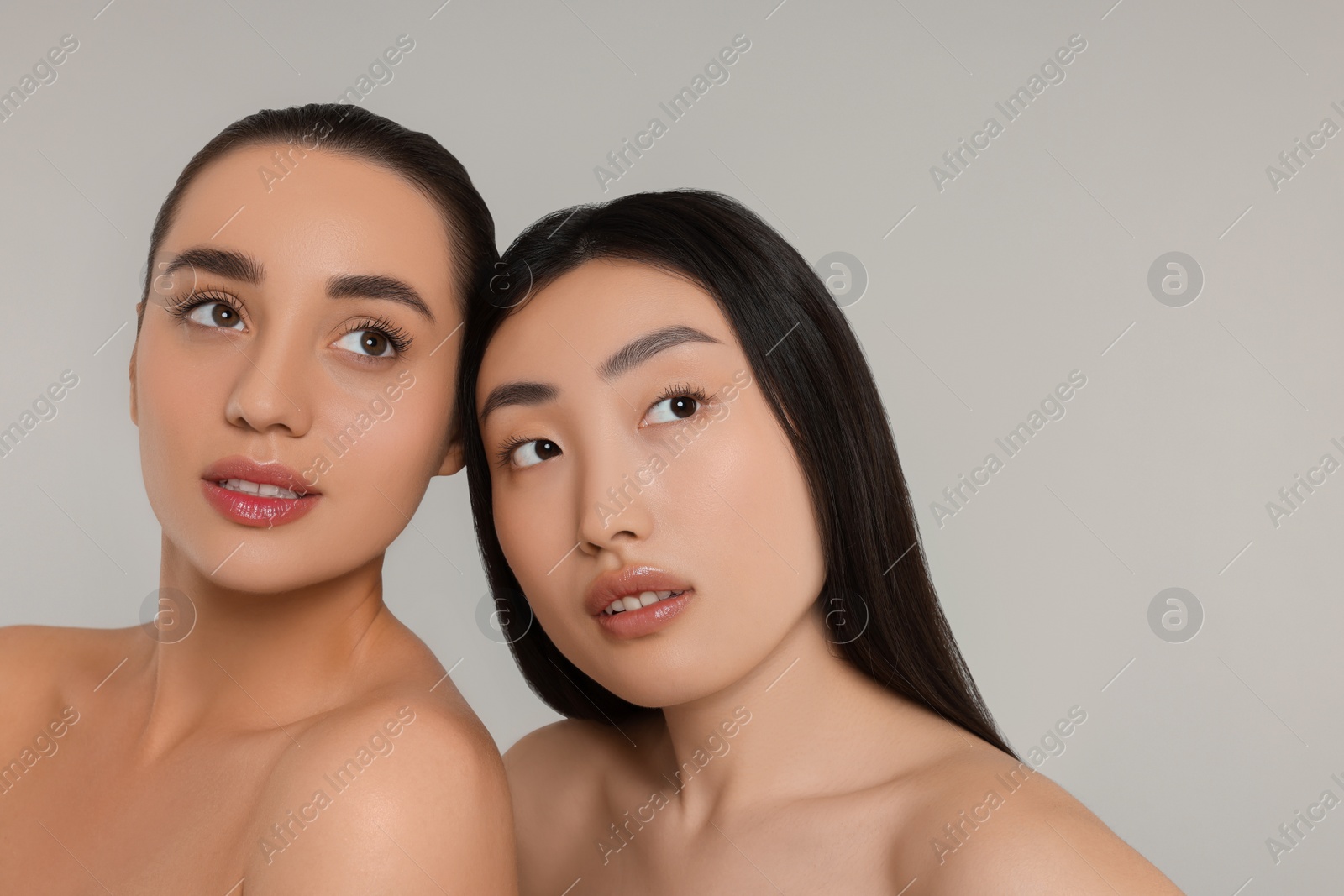 Photo of Portrait of beautiful young women on light grey background. Space for text