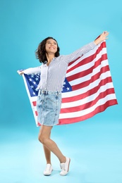 happy young woman with USA flag on blue background