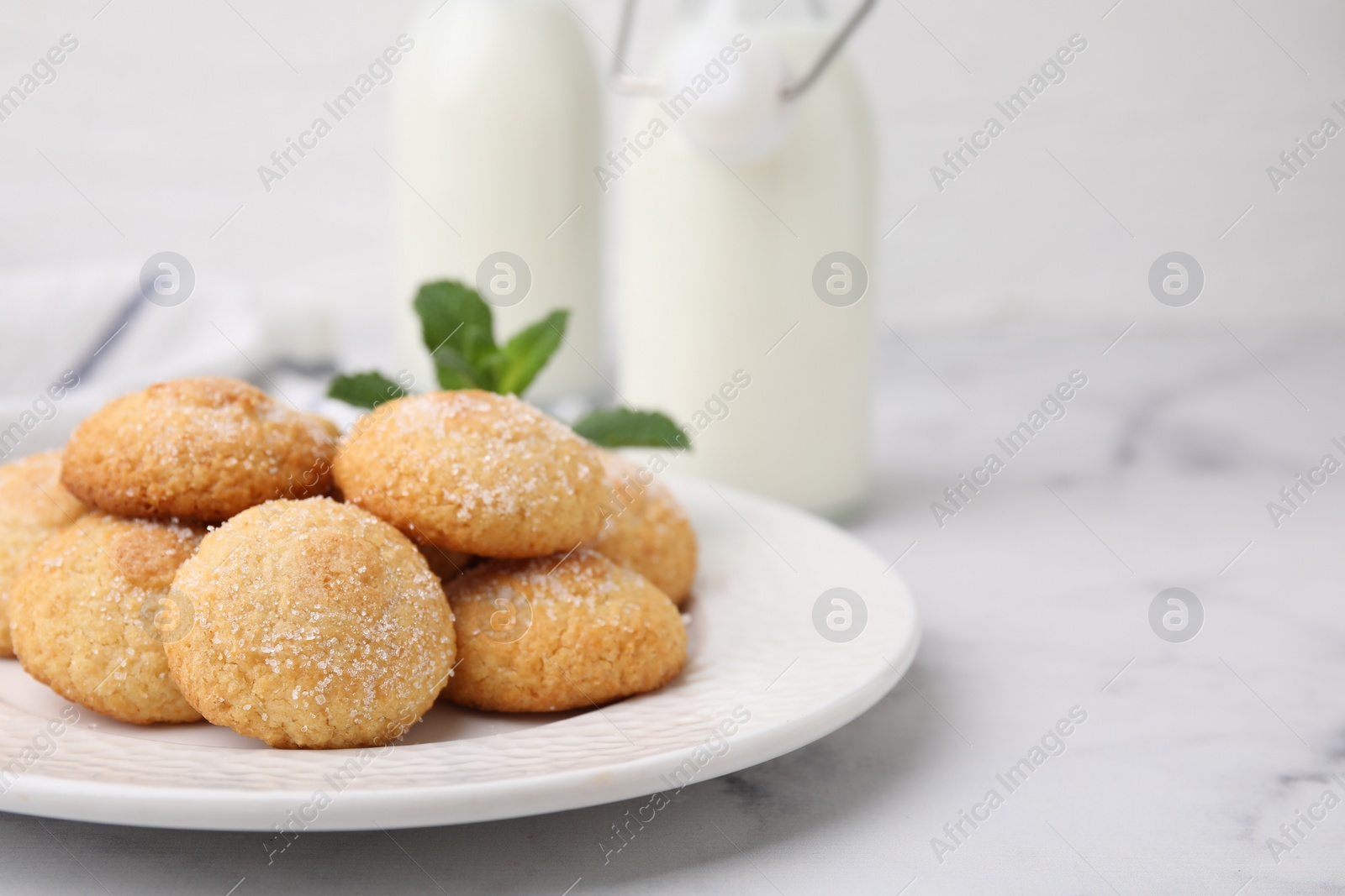 Photo of Tasty sweet sugar cookies on white marble table, closeup. Space for text