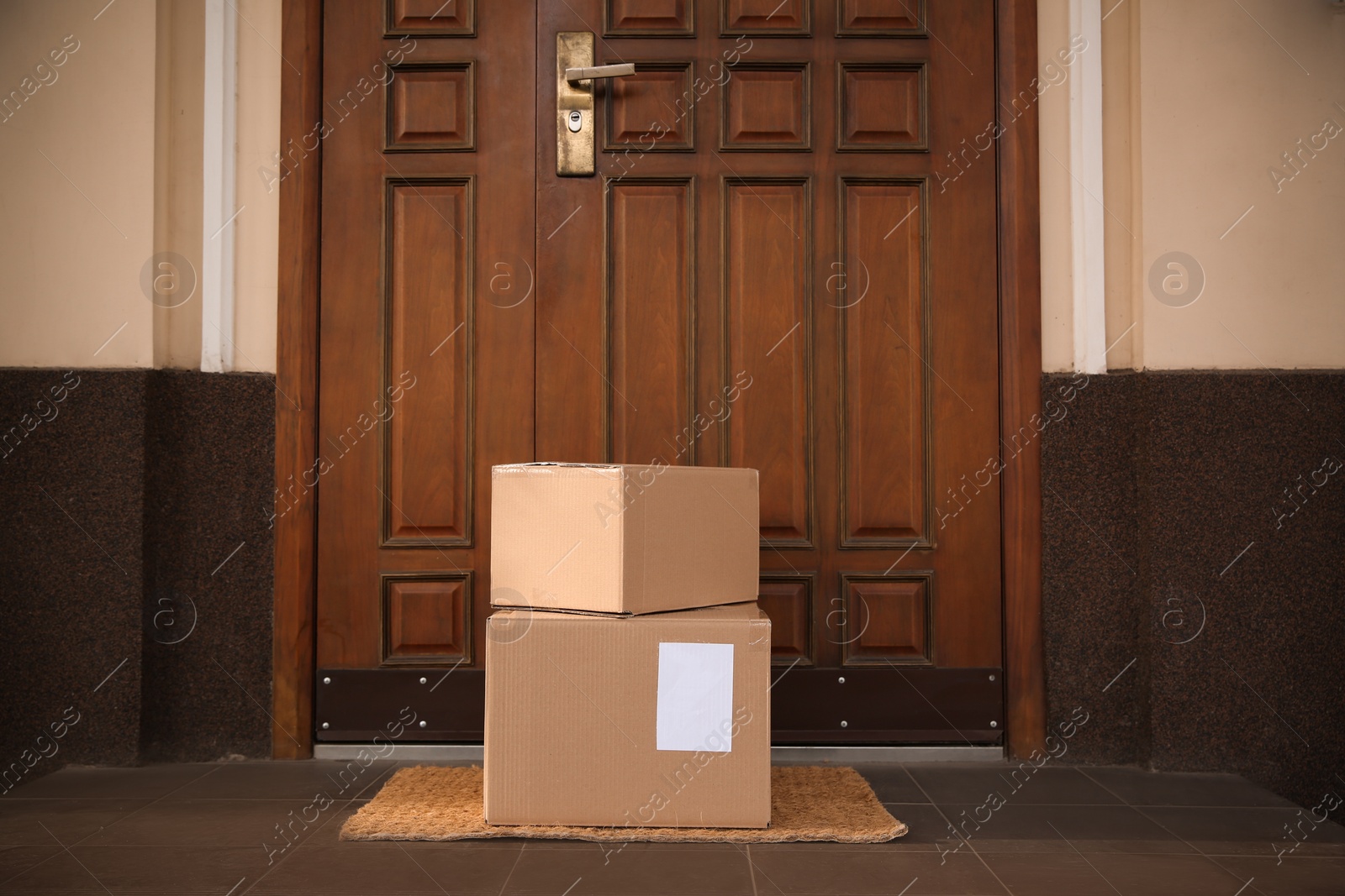 Photo of Delivered parcels on door mat near entrance