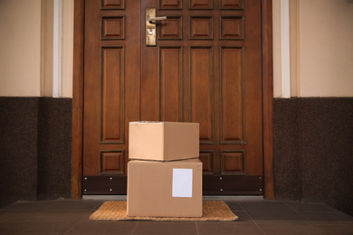 Photo of Delivered parcels on door mat near entrance