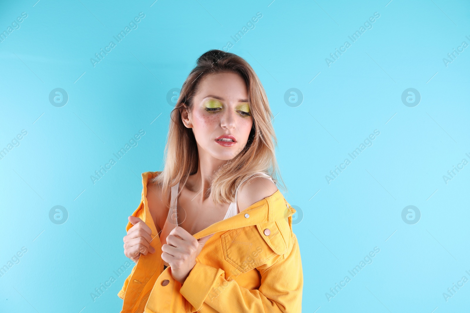 Photo of Beautiful young woman posing on color background. Summer fashion