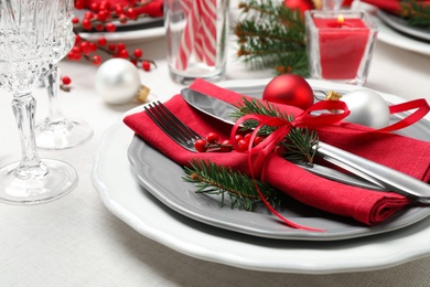 Photo of Festive table setting with beautiful dishware and Christmas decor on white background