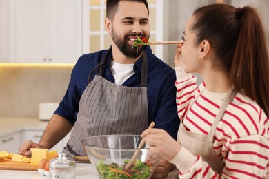 Photo of Happy lovely couple cooking together in kitchen