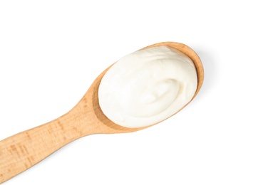 Wooden spoon with sour cream on white background, top view