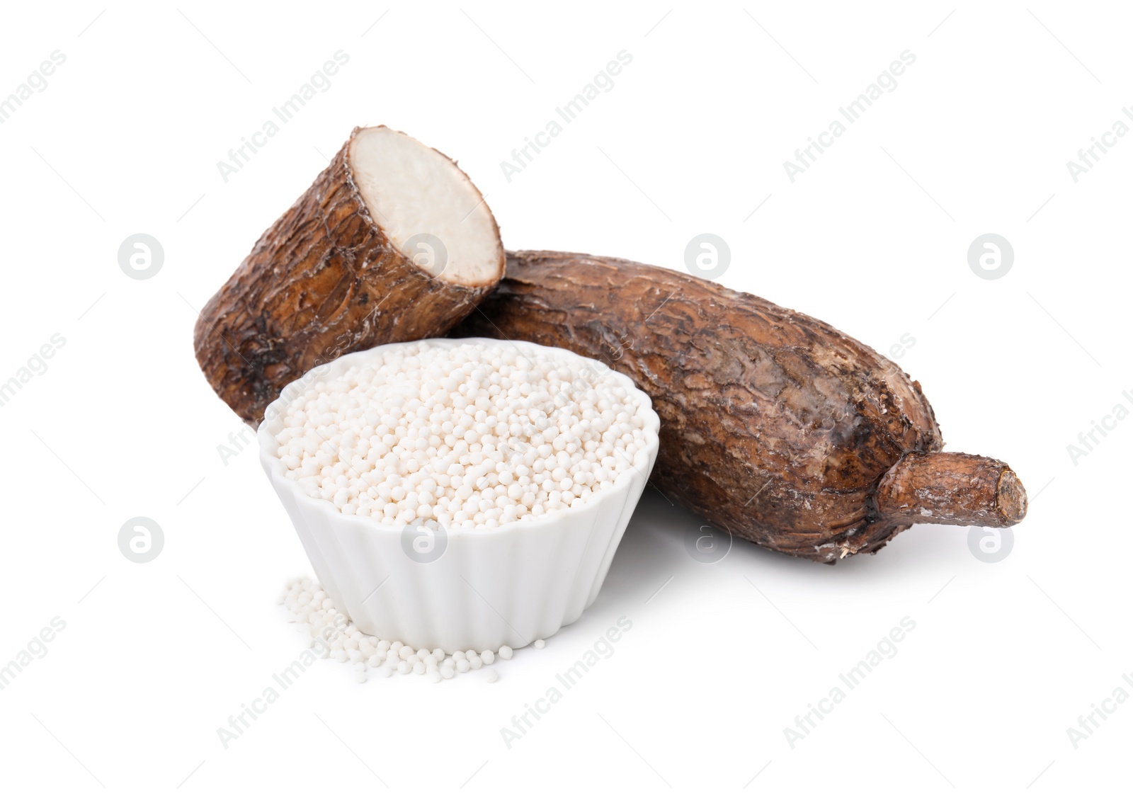 Photo of Tapioca pearls in bowl and cassava roots isolated on white